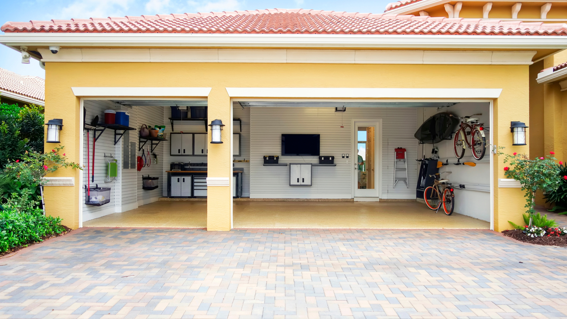 A yellow garage with a bicycle and a bicycle mounted to the side of it